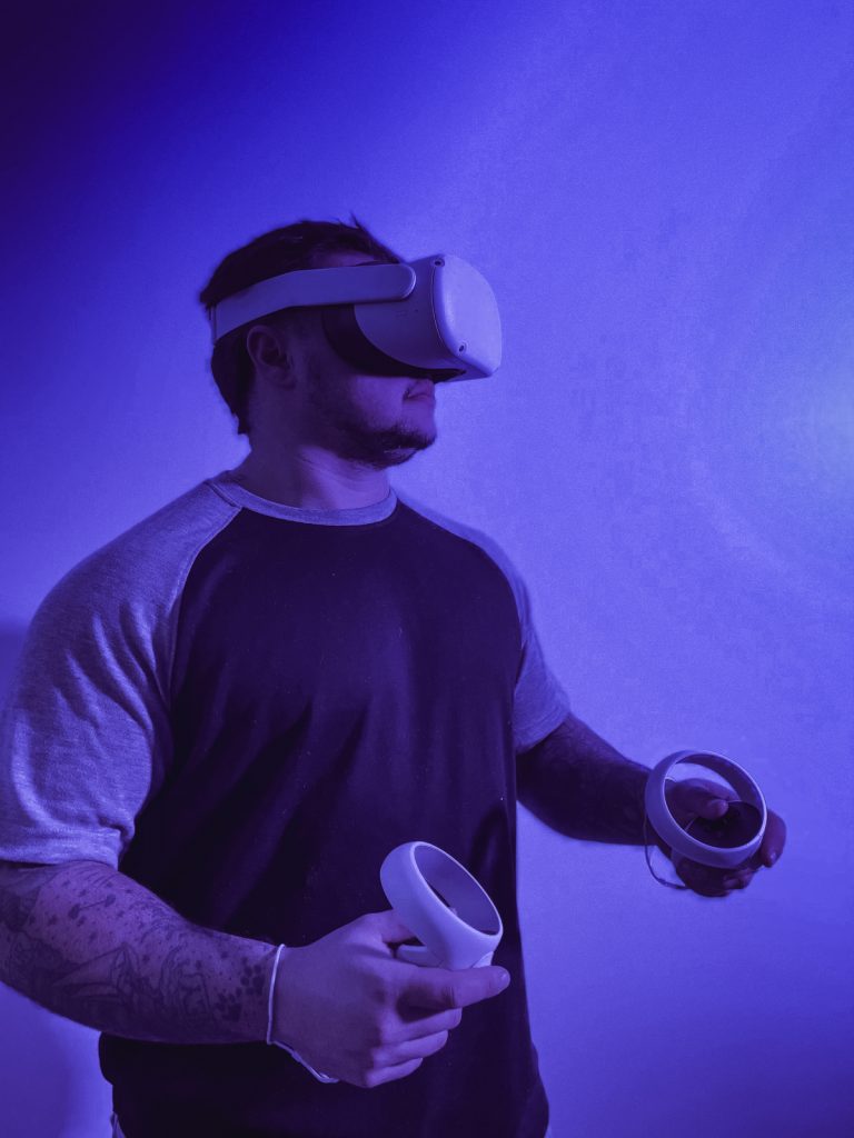 A man immersed in virtual reality with a headset on.